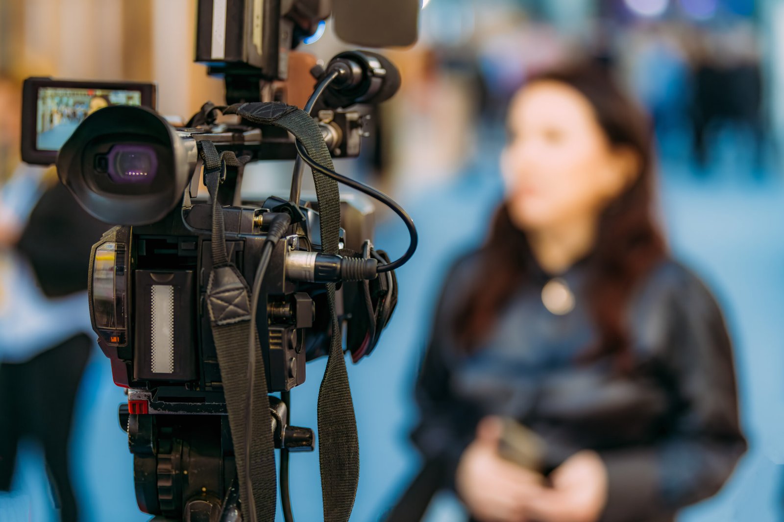 Businesswoman Interviewed by Media at a Trade Fair